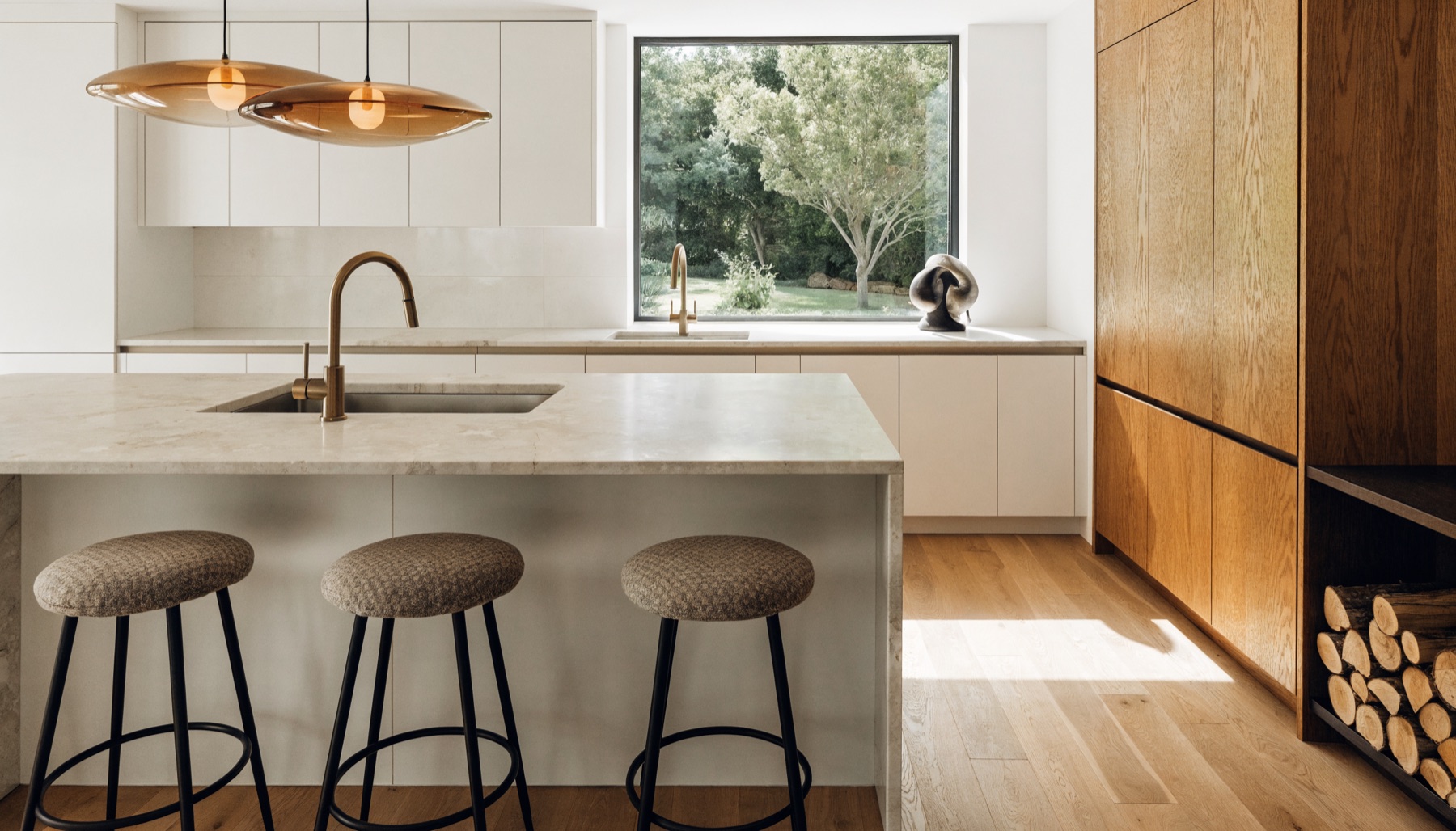A renovated Australian kitchen with stone benchtops and oak cabinetry