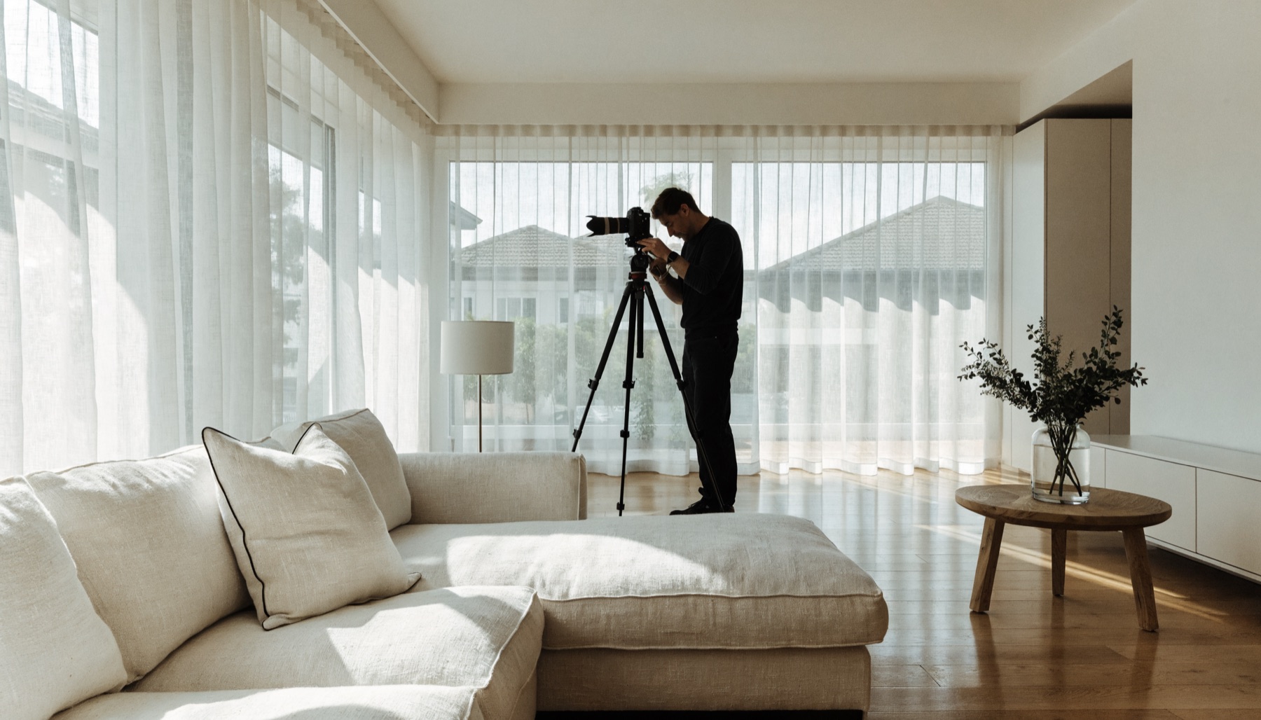 A professional photographer shooting a bright Australian living room